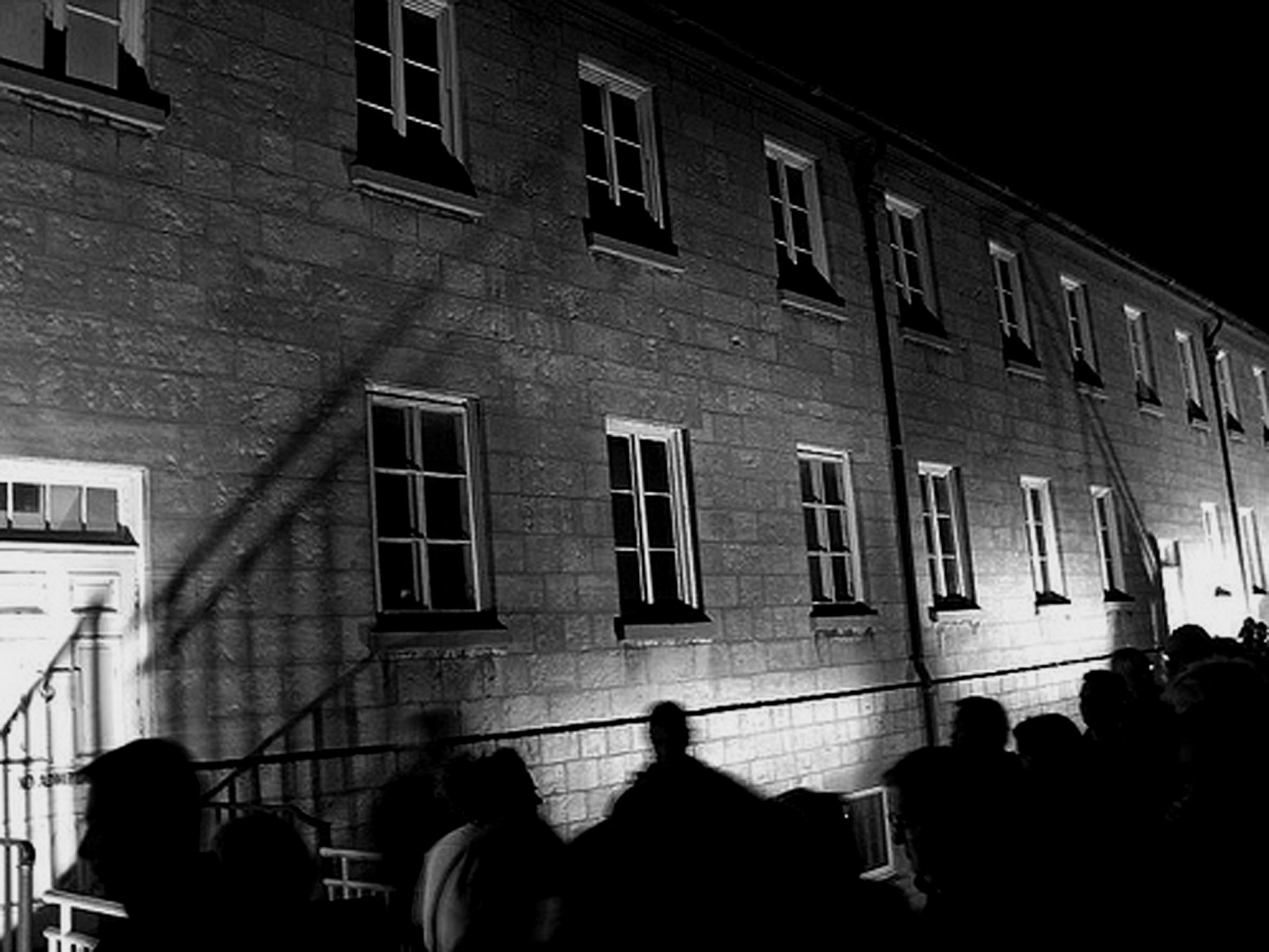 Black and white image of a building at night