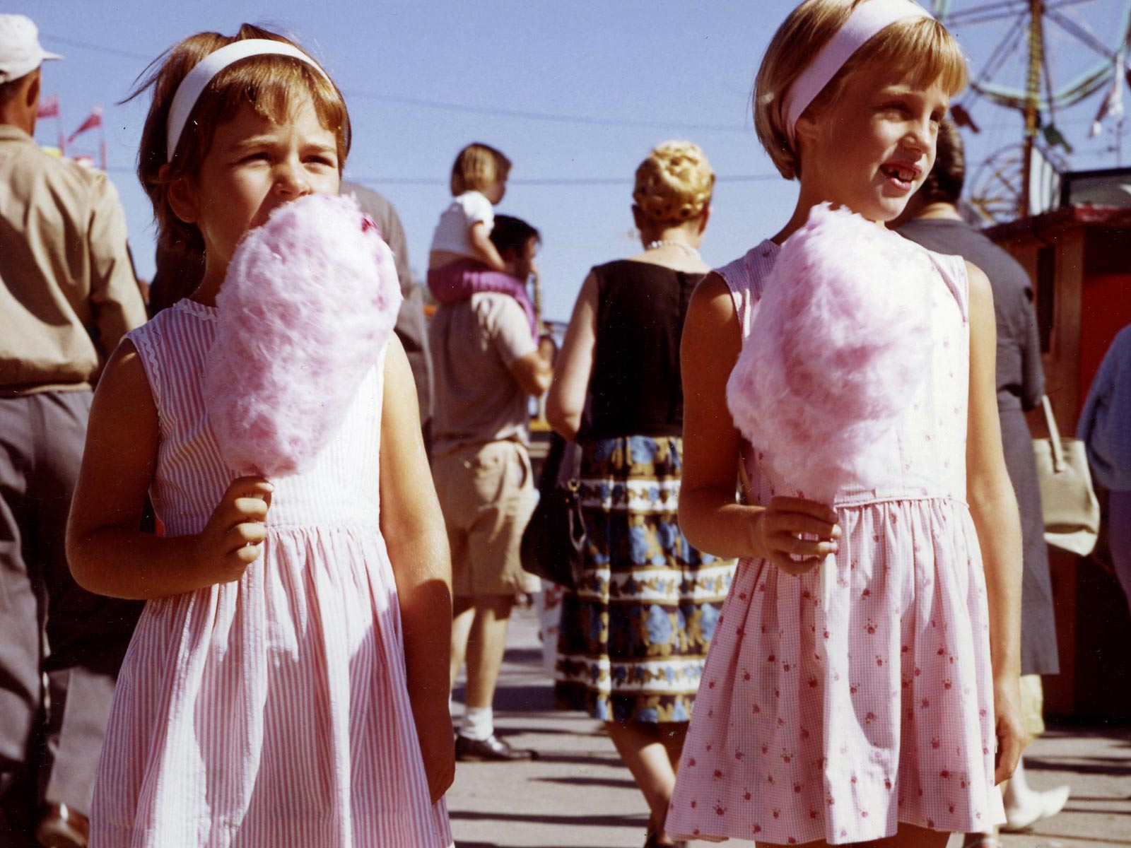 Two young girls at the fair with cotton candy