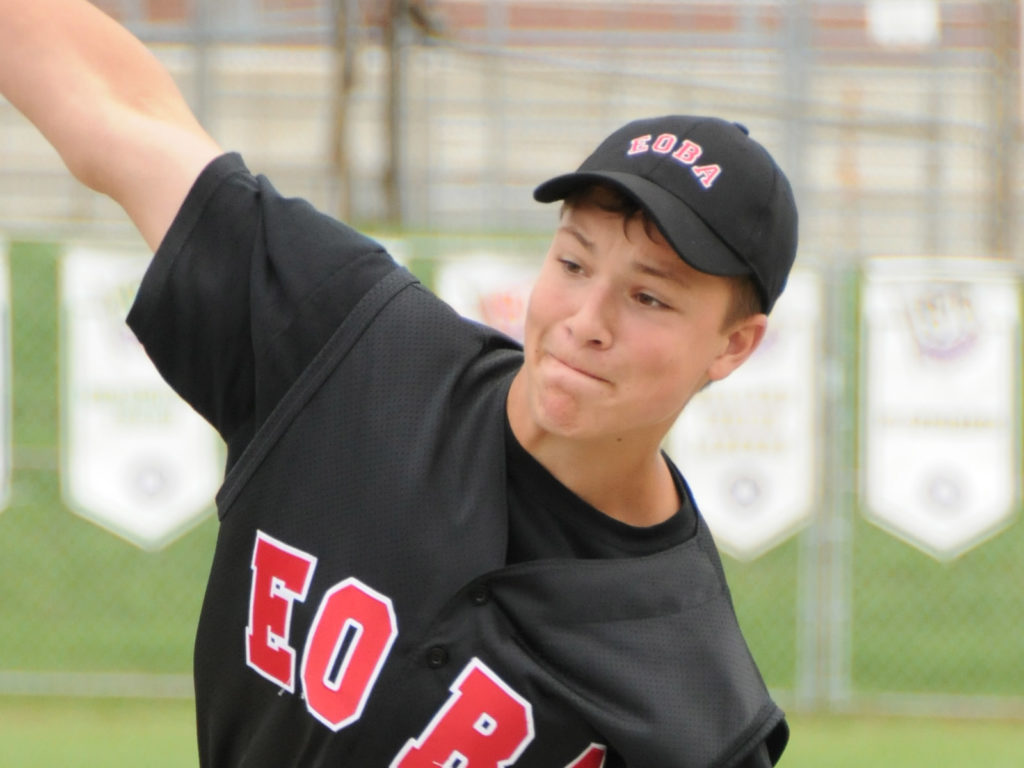 young adult male throwing a base ball