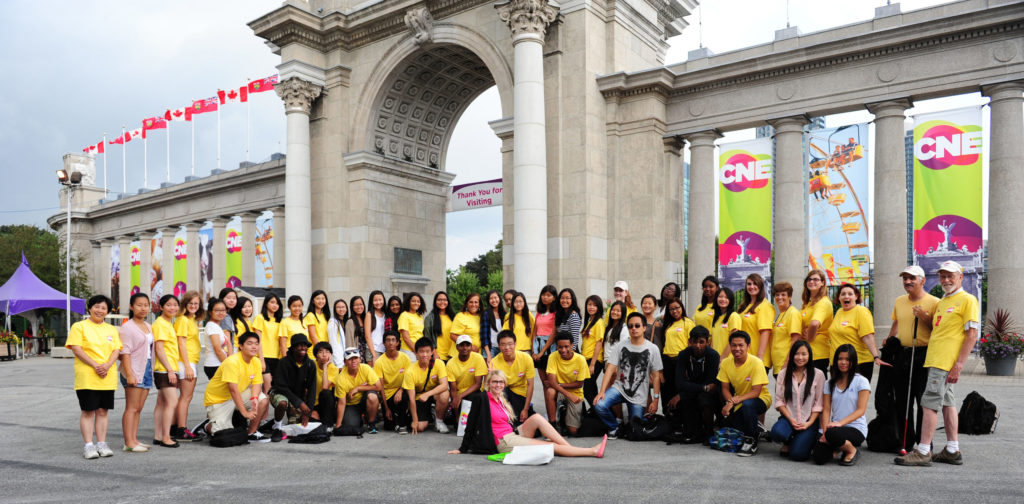 CNE gates with large group of volunteers in front of gates
