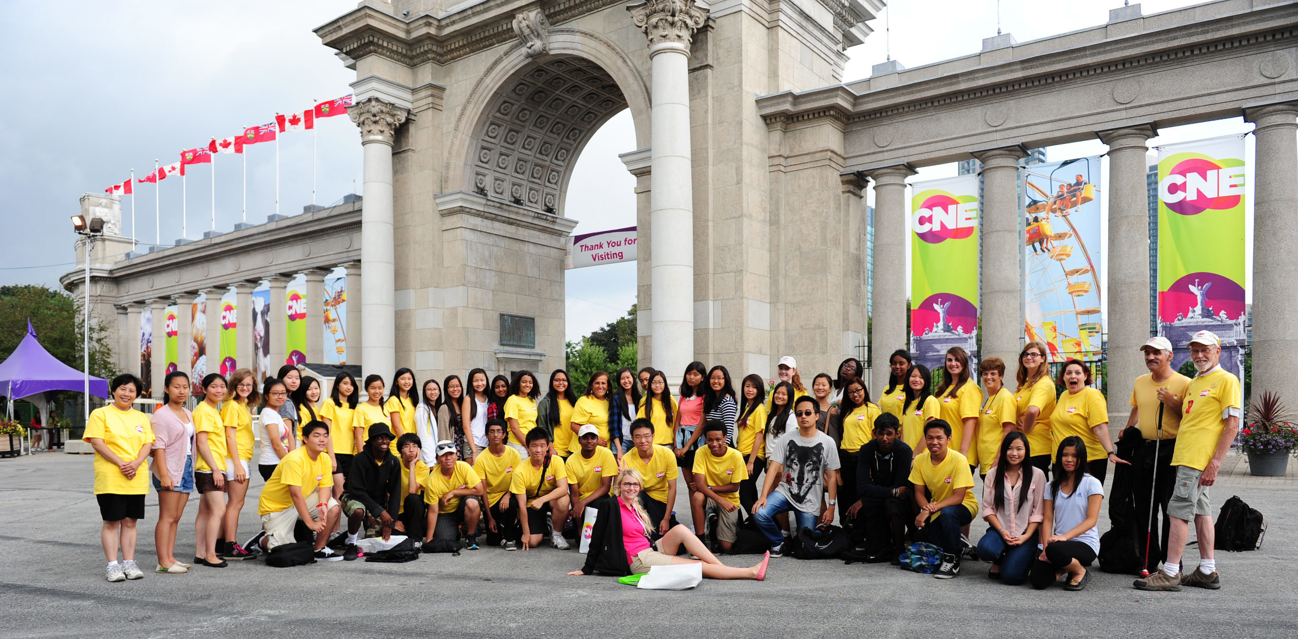 CNE gates with large group of volunteers in front of gates