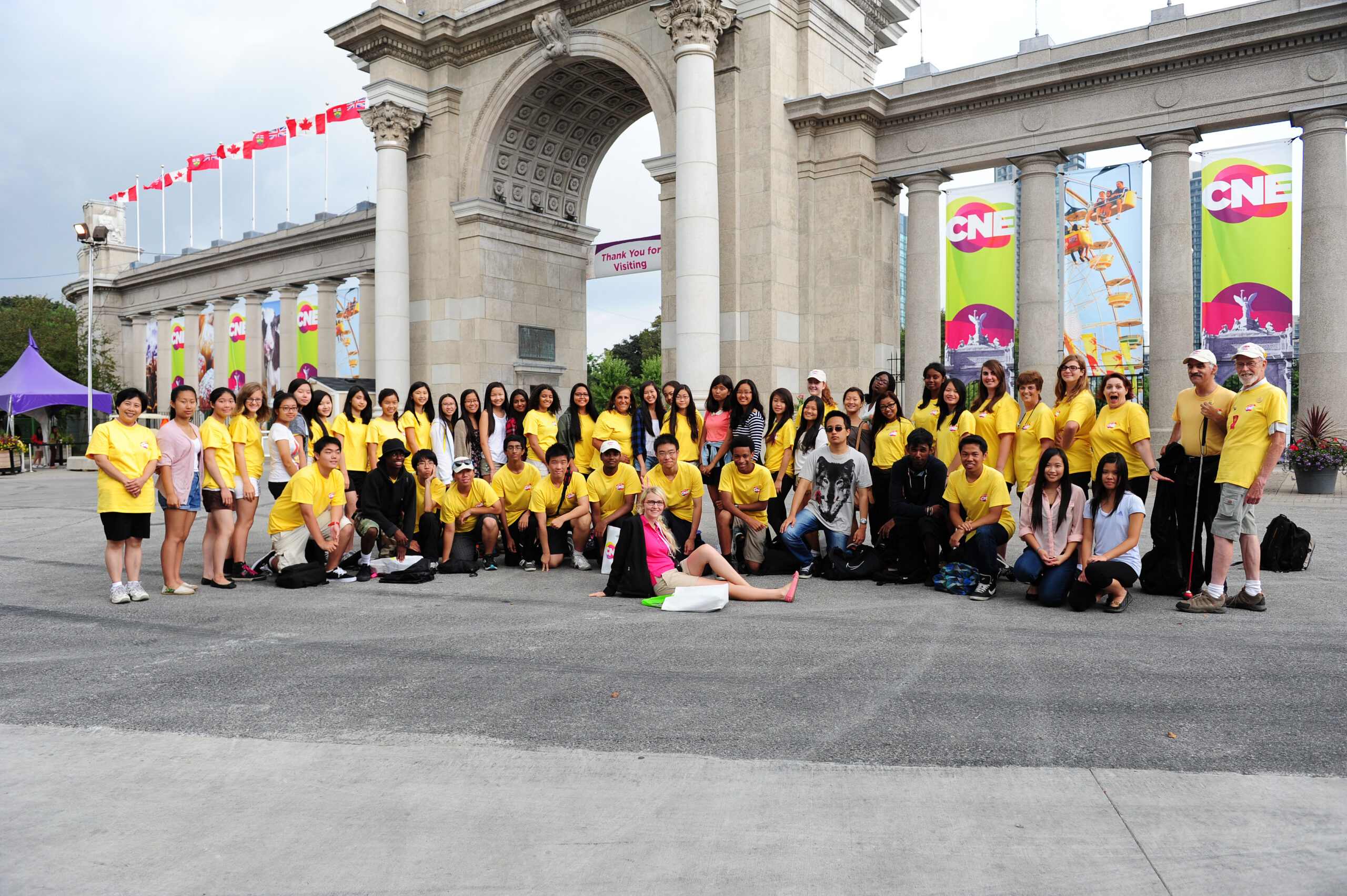 CNE gates with large group of volunteers in front of gates