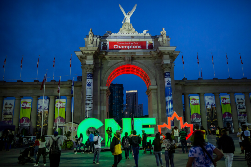 The Princes' Gates and the CNE sign lit up at night