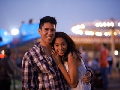 Image of two individuals in the Midway at night.