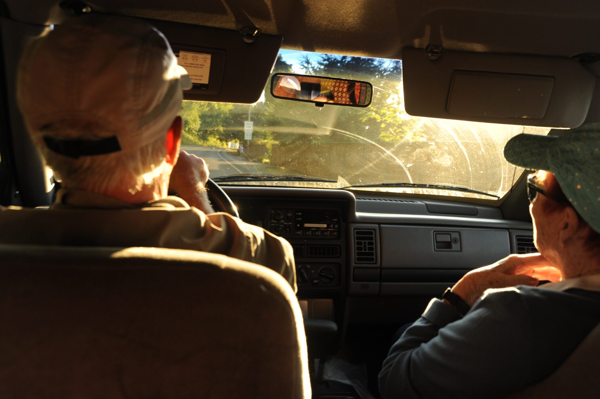 Elderly couple driving in a car.