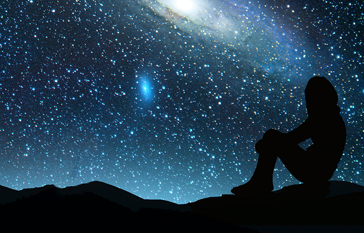 Silhouette of a girl sitting with a starry night sky in the background.