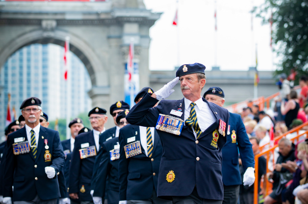 Photo of marchers in front of the Princes' Gates during the annual Warriors' Day Parade.