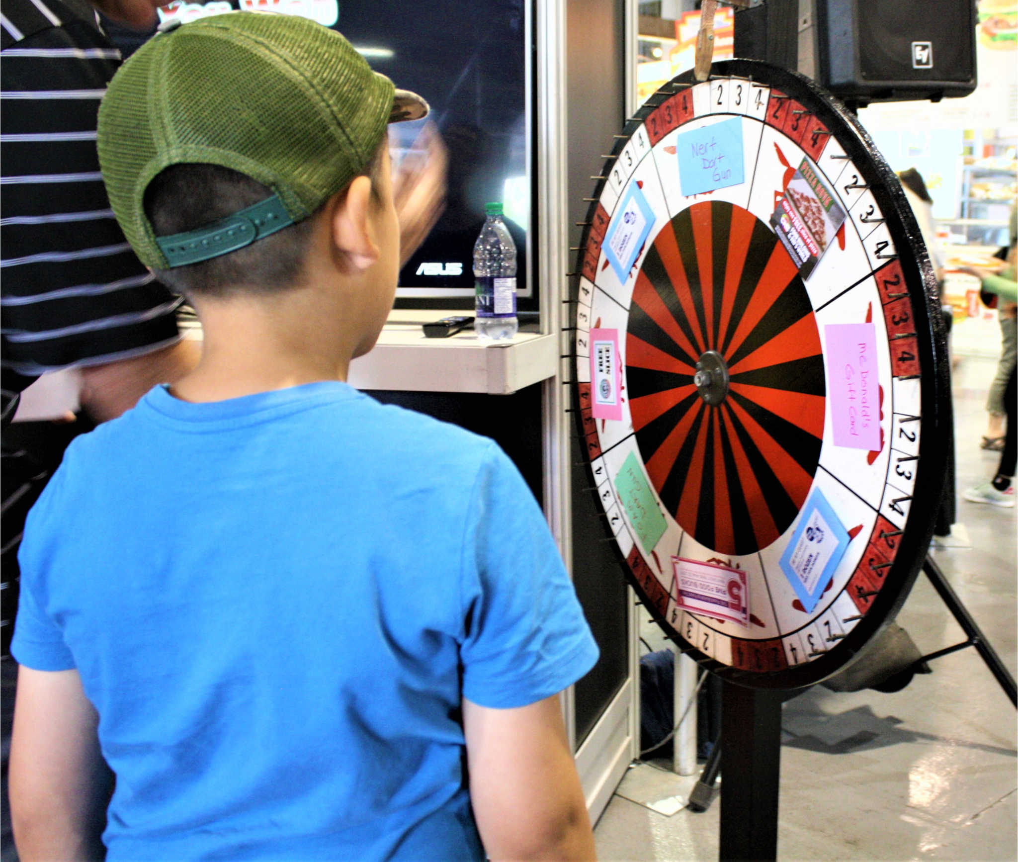 Food Products Day. Image of a young child spinning a wheel to win a prize.