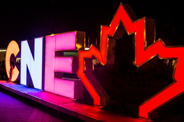 A photo of the CNE sign lit up at night