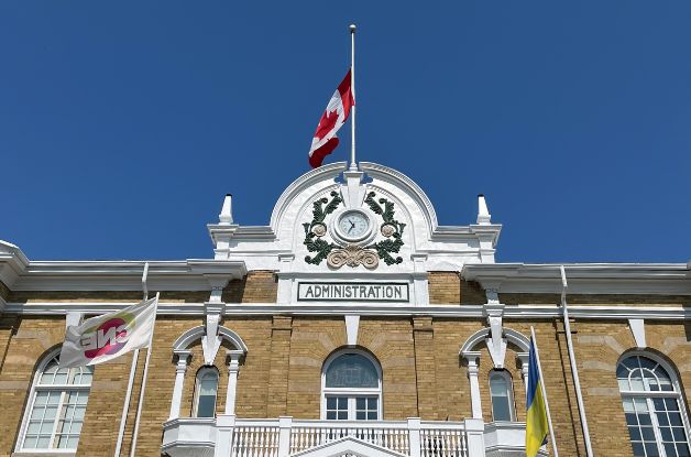 The front of the Administrative Building with the Canadian Flag at half-mast