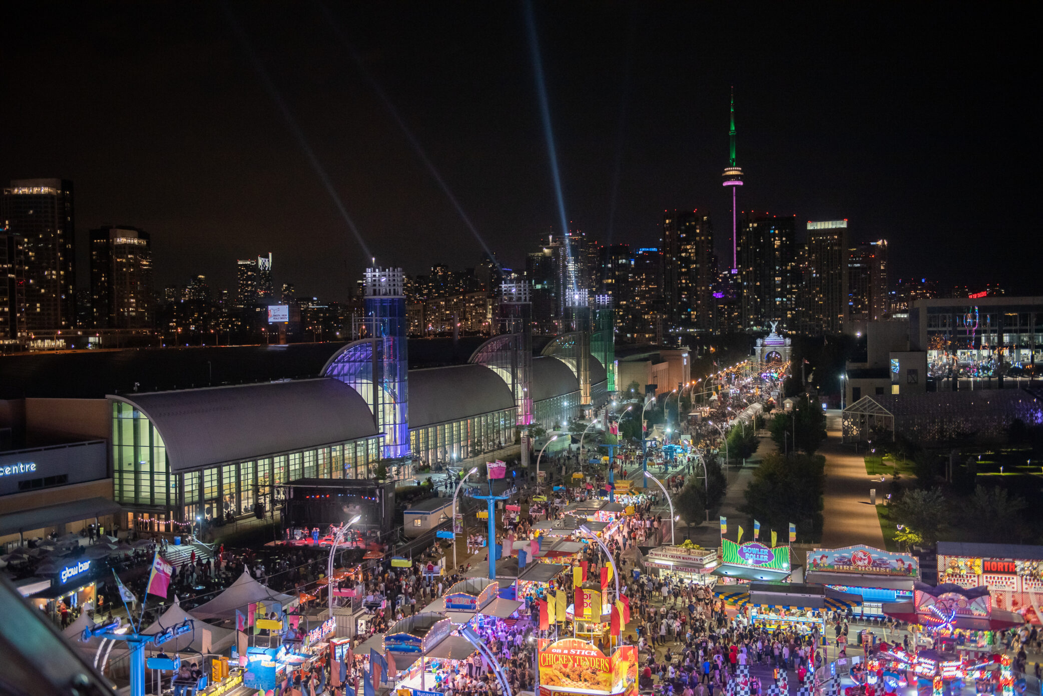 Aerial view of CNE at night, the the stands are light up and there are many people