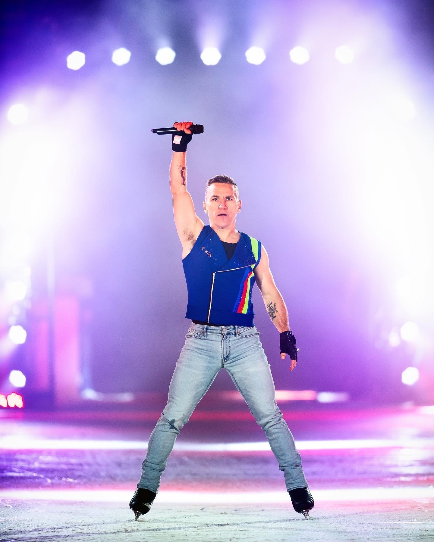 Guy in skates holding a microphone up